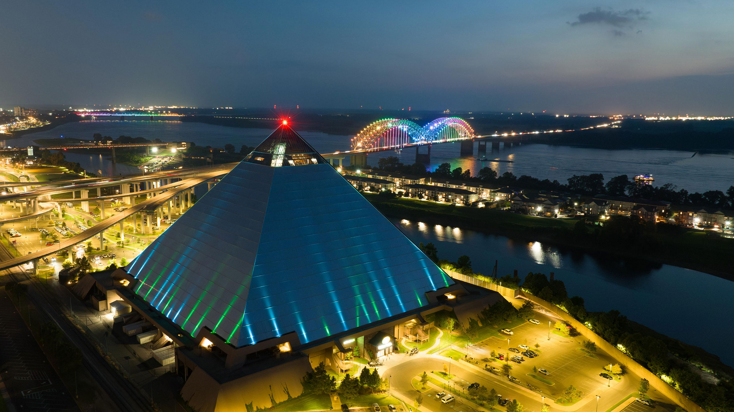 The Memphis riverfront, illuminated bridge, and Pyramid at night